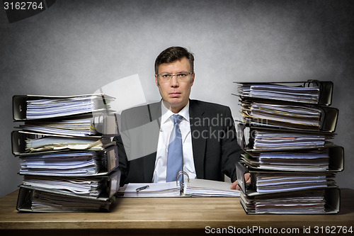 Image of Overworked depressed businessman