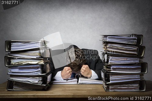 Image of Overworked frustrated businessman