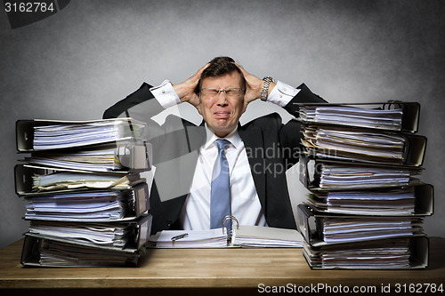 Image of Overworked stressed businessman