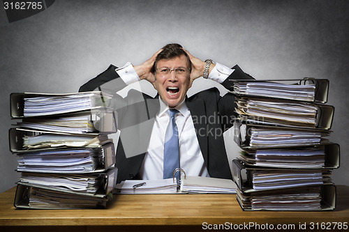 Image of Overworked crying businessman