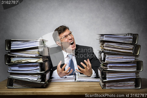 Image of Overworked crying businessman