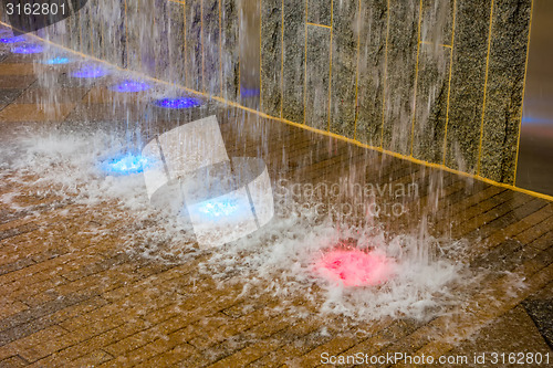 Image of manmade waterfall with colorful led lights