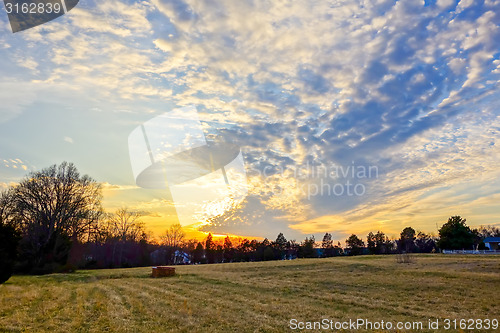 Image of sunset over farm field landscape