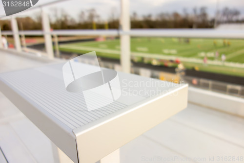 Image of empty bleacher seating in rows, taken in a modern school sports 