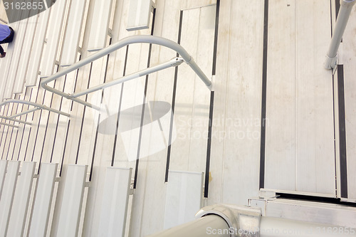 Image of empty bleacher seating in rows, taken in a modern school sports 