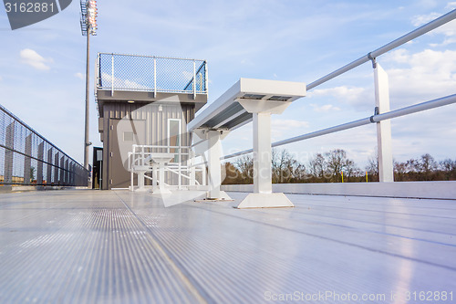 Image of empty bleacher seating in rows, taken in a modern school sports 