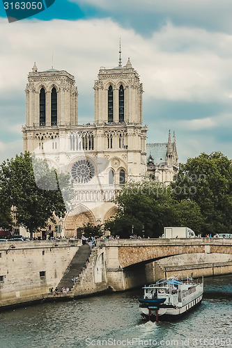 Image of Notre Dame  with boat on Seine, France