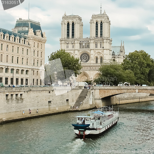 Image of Notre Dame  with boat on Seine, France