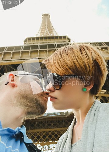 Image of Young couple near the Eiffel Tower in Paris