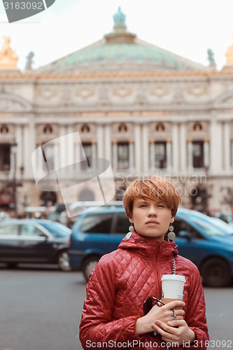 Image of blonde woman portrait in front of Opera theater Paris, France.