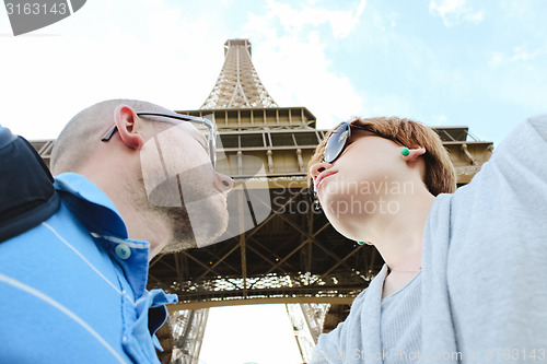 Image of Young couple near the Eiffel Tower in Paris