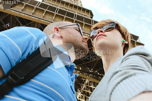 Image of Young couple near the Eiffel Tower in Paris