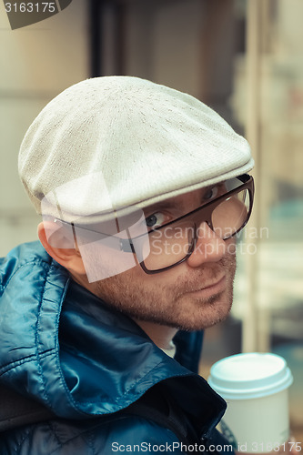 Image of Bald man drinking coffee