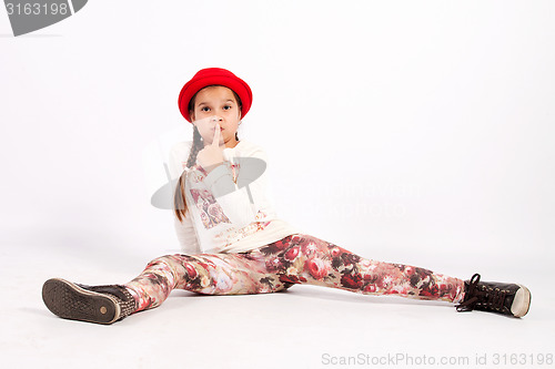 Image of Little girl sitting on the floor