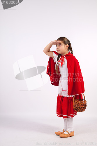 Image of little girl in costume looking into the distance