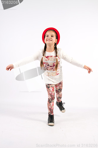 Image of Little girl in dance creations with red hat