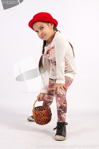 Image of Little girl holding a basket in her hand