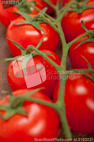 Image of fresh cherry tomatoes on a cluster