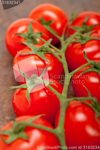 Image of fresh cherry tomatoes on a cluster
