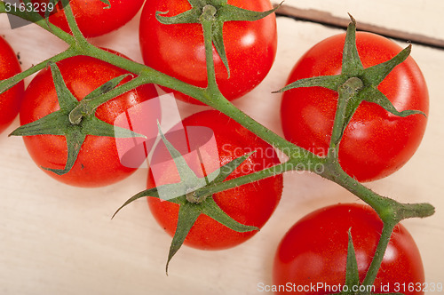Image of fresh cherry tomatoes on a cluster