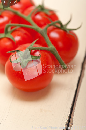 Image of fresh cherry tomatoes on a cluster