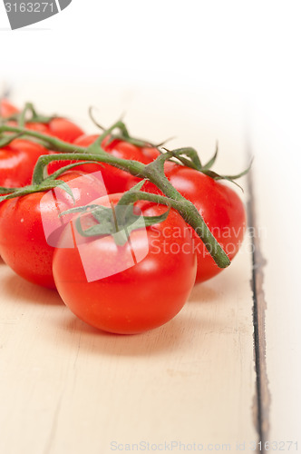 Image of fresh cherry tomatoes on a cluster