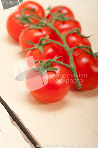 Image of fresh cherry tomatoes on a cluster