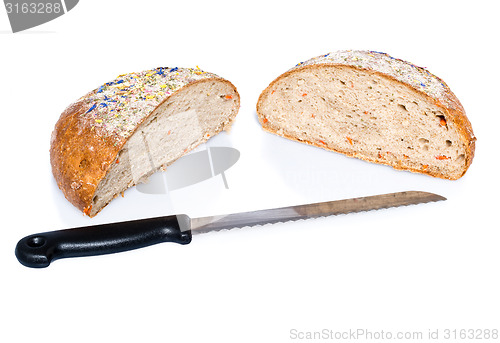 Image of Two half loafs of bread with knife