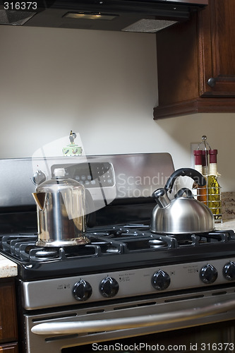 Image of tea pot and coffee pot on stove