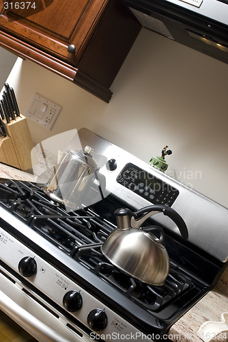 Image of tea pot and coffee pot on stove