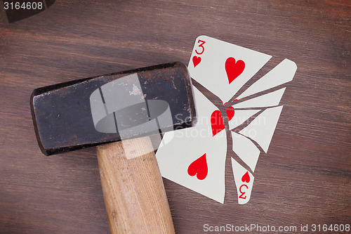 Image of Hammer with a broken card, three of hearts