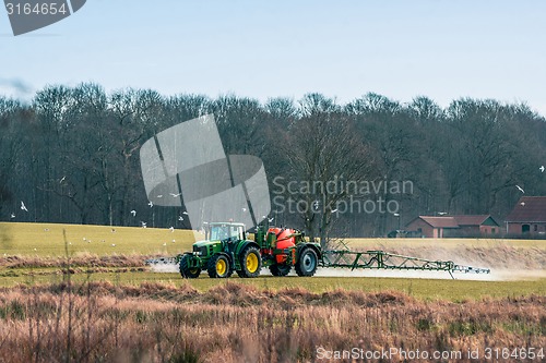 Image of Tractor fertilizing a field