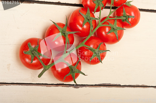 Image of fresh cherry tomatoes on a cluster