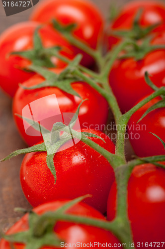 Image of fresh cherry tomatoes on a cluster
