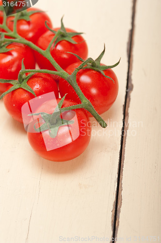 Image of fresh cherry tomatoes on a cluster