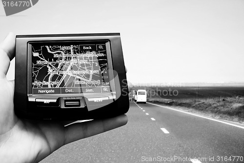 Image of GPS Vehicle navigation system in a man hand.