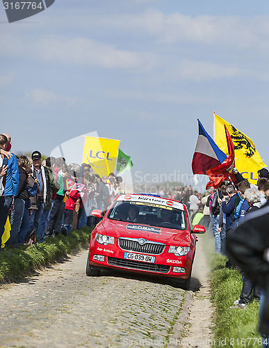 Image of Official Red Car on the Roads of Paris Roubaix Cycling Race