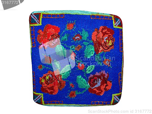 Image of blue pillow embroidered with red thread