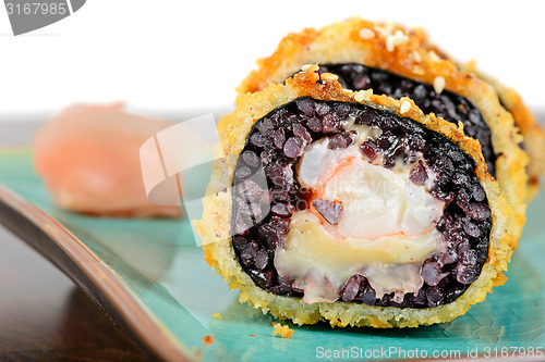 Image of Baked sushi rolls served on turquoise plate