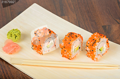 Image of Closeup California maki sushi in row ot the table