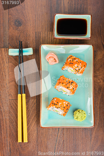 Image of Sushi rolls on the wooden table. Aerial view. 