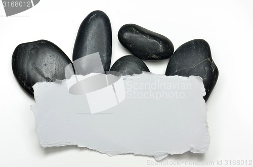 Image of White paper and stones