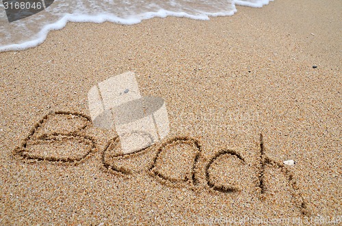 Image of Beach word written on the sandy beach