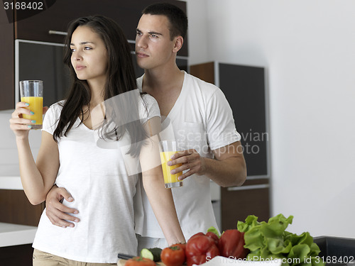 Image of happy young couple in kicthen