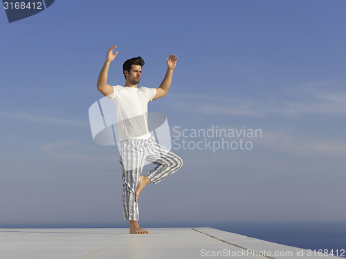 Image of young man practicing yoga