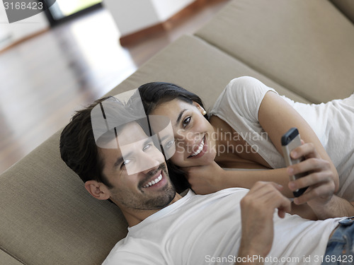 Image of young couple making selfie together at home