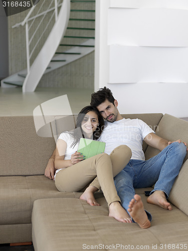 Image of young couple making selfie together at home