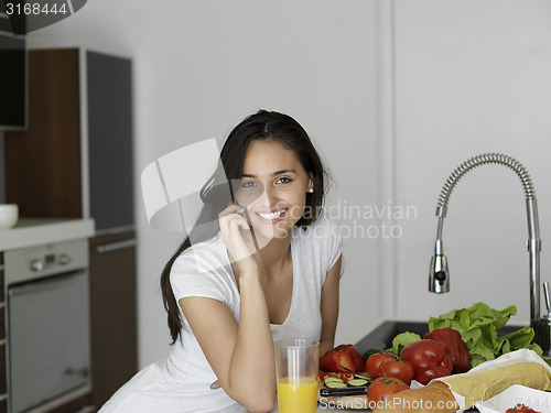 Image of Young Woman Cooking in the kitchen