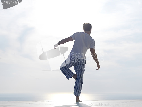 Image of young man practicing yoga