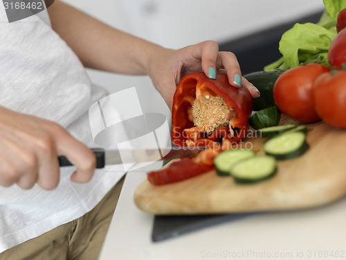 Image of Young Woman Cooking in the kitchen